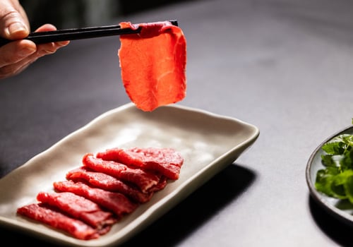 Professionally presented Ocean Beef cuts being picked up by chopsticks