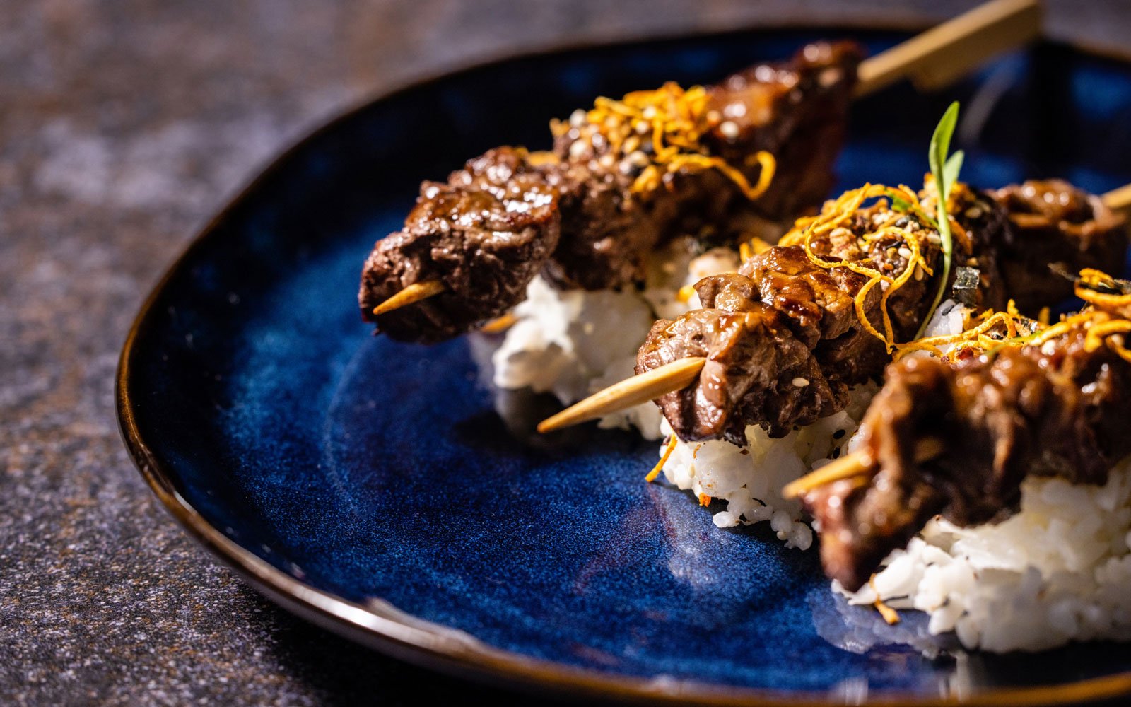Beef skewers on a bed of rice