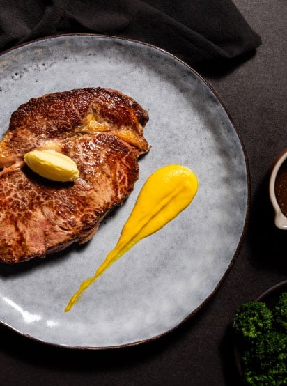 Ribeye steak with puree and broccolini
